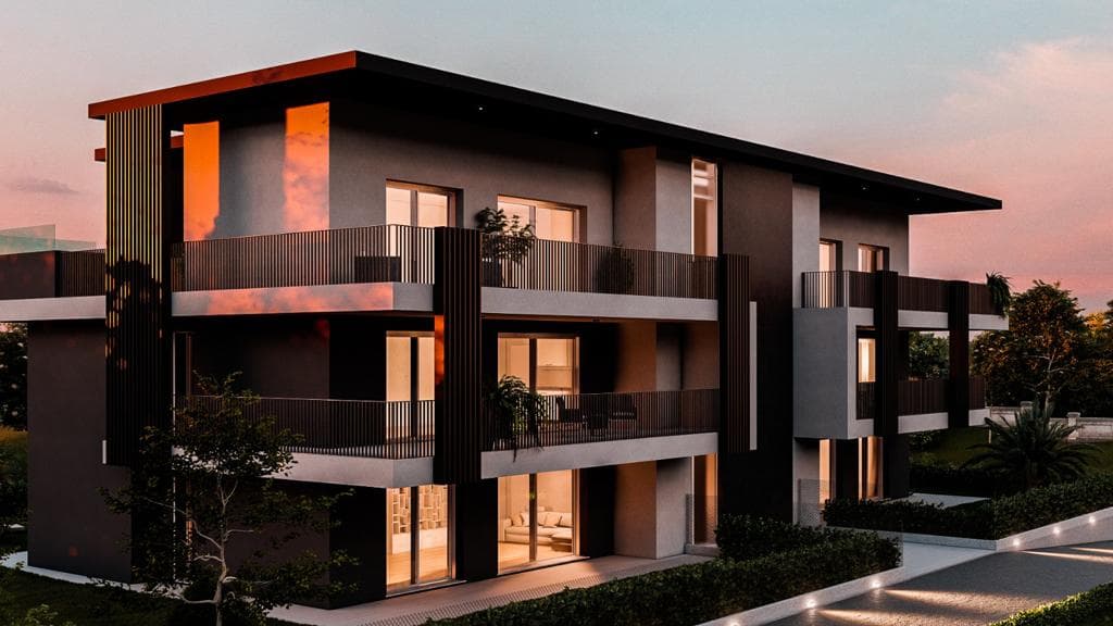 Residenza Superga a Cornate d’Adda: render serale della palazzina con finestre illuminate
